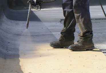 Coating systems over  spray foam roof systems